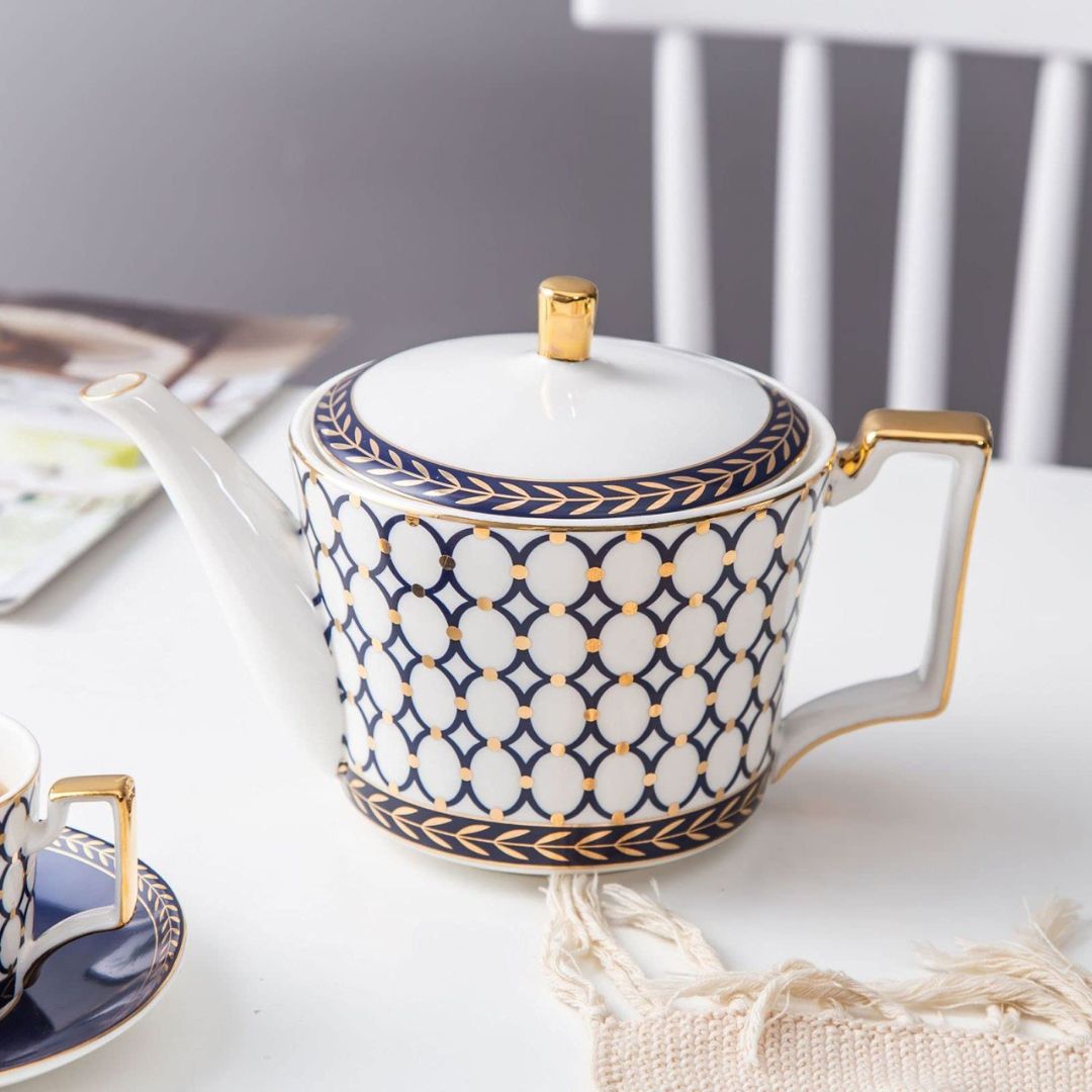 Porcelain coffee set with bone china teacups and white ceramic serving pieces